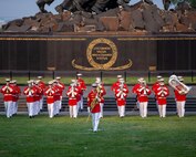 Marines of “The Commandants Own,” U.S. Marine Drum and Bugle Corps, march on to the parade deck during a Tuesday Sunset Parade at the Marine Corps War Memorial, Arlington, VA, June 15 2021.