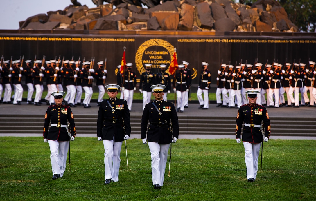 Barracks Marines march on to the parade deck during a Tuesday Sunset Parade at the Marine Corps War Memorial, Arlington, VA, June 15 2021.