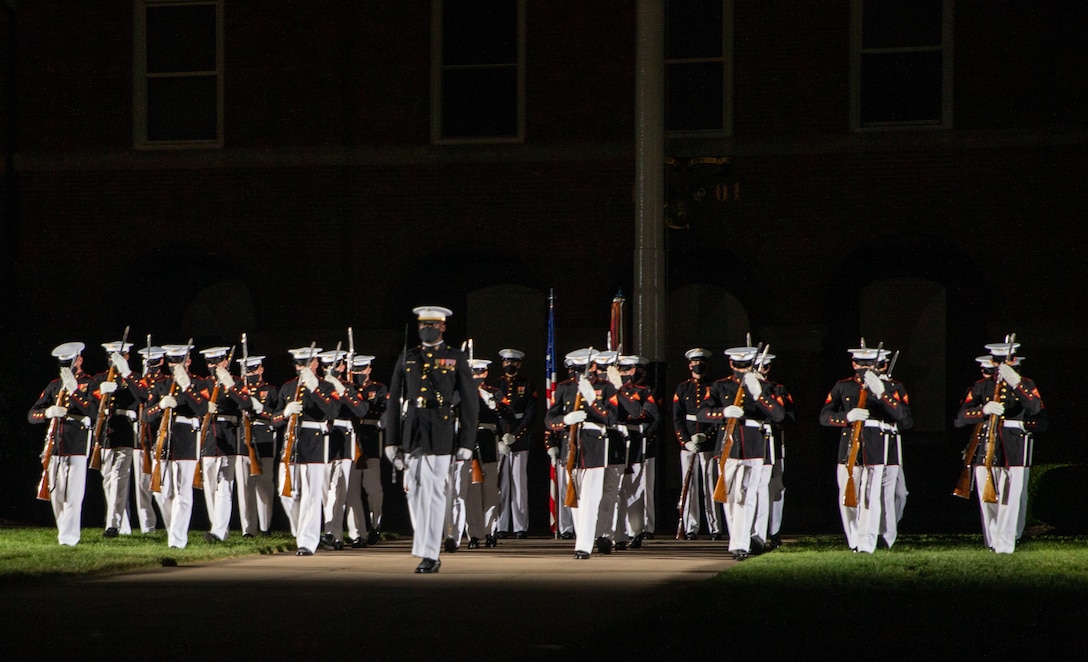 The U.S. Marine Corps Silent Drill Platoon begins their sequence during the Friday Evening Parade at Marine Barracks Washington, July 16, 2021. The hosting official for the evening was Gen. Gary L. Thomas, the Assistant Commandant of the Marine Corps, and the Guest of Honor was Major General Andrew Freeman AM, Head of Australian Defence Staff.
