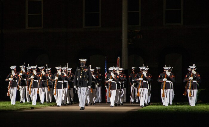 The U.S. Marine Corps Silent Drill Platoon begins their sequence during the Friday Evening Parade at Marine Barracks Washington, July 16, 2021.