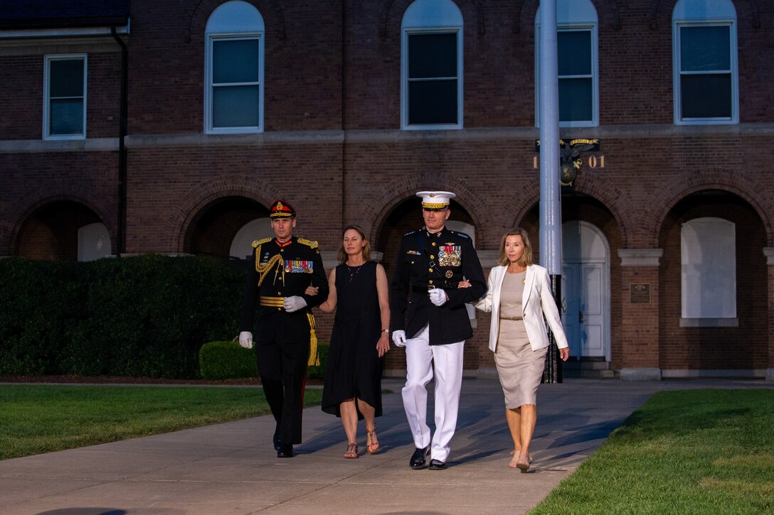 The Guest of Honor, hosting official and their spouses walk down Center Walk to their seats during the Friday Evening Parade at Marine Barracks Washington, July 16, 2021.