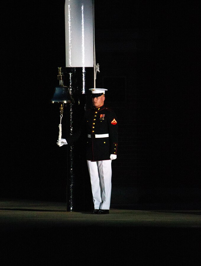 A Barracks Marine strikes the bell signaling the beginning of the Friday Evening Parade at Marine Barracks Washington, July 16, 2021. The hosting official for the evening was Gen. Gary L. Thomas, the Assistant Commandant of the Marine Corps, and the Guest of Honor was Major General Andrew Freeman AM, Head of Australian Defence Staff.