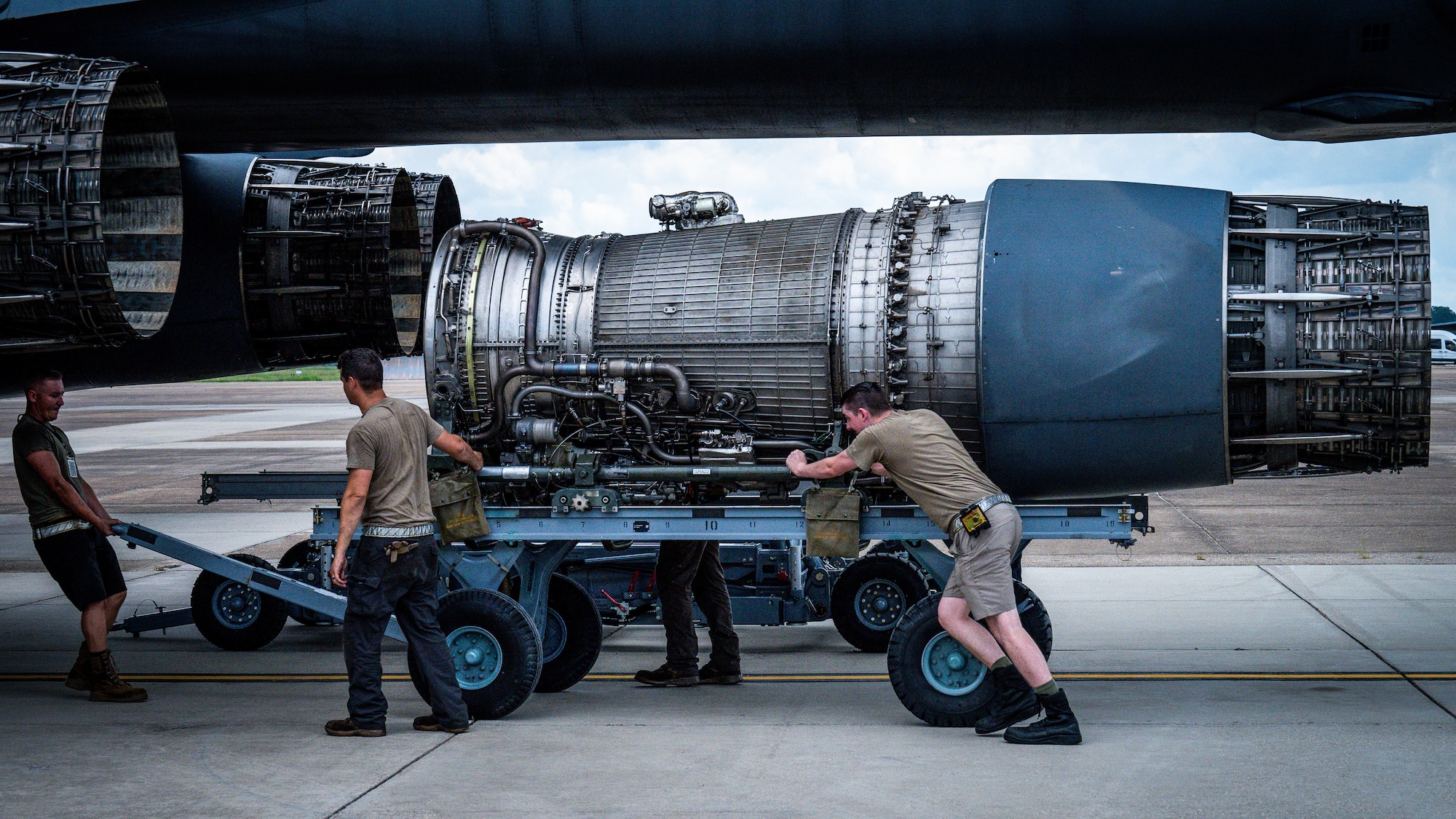 Airmen from Dyess Air Force Base, Texas, remove a F-101 engine from a B-1B Lancer at Barksdale Air Force Base, Louisiana, July 7, 2021.