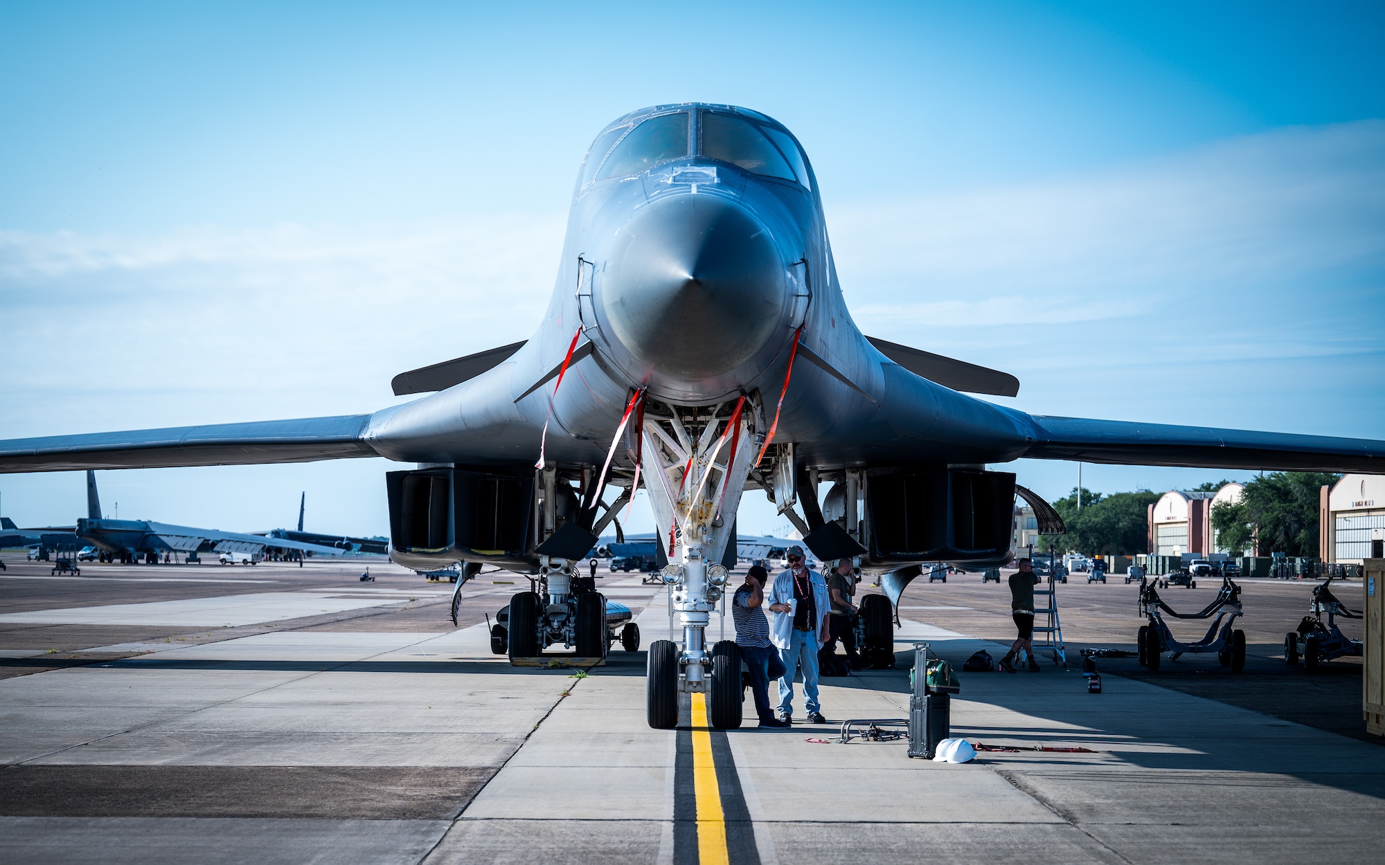 Airmen from Dyess Air Force Base, Texas, prepare to remove parts from a decommissioned B-1B Lancer at Barksdale Air Force Base, Louisiana, July 7, 2021.