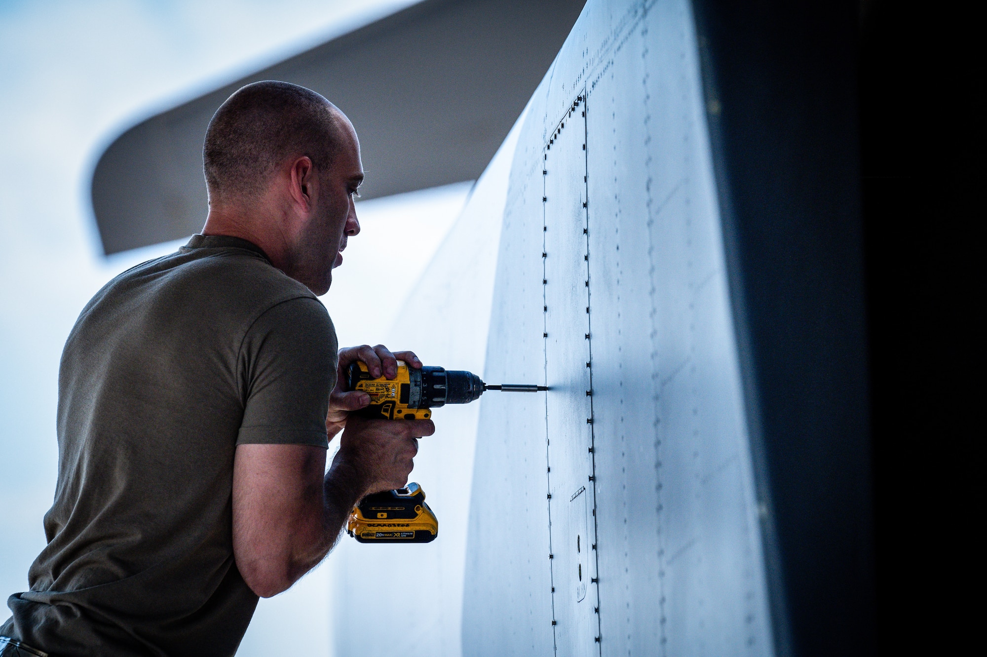 An Airman from Dyess Air Force Base, Texas, removes a panel from the rear of a B-1B Lancer at Barksdale Air Force Base, Louisiana, July 7, 2021.