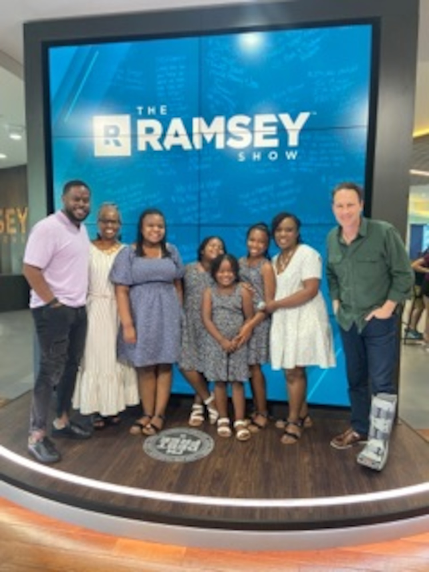 U.S. Air Force Master Sgt. Traci Coston stands next to her family and the hosts of The Ramsey Show on The Ramsey Show set, May 28, 2021. Coston appeared on the show to explain how she paid off $36,000 in student loan and credit card debt in 14 months. She currently serves as the 9th Air Force (Air Forces Central)/Financial Management superintendent and also holds a financial coaching master’s certification in personal finance to help others achieve their financial dreams.
