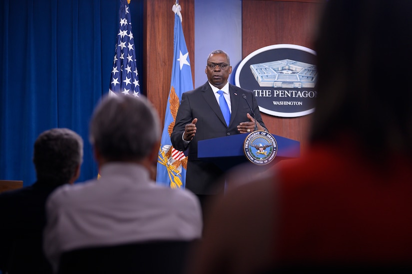 Secretary of Defense Lloyd J. Austin III speaks to a seated audience at a lectern.