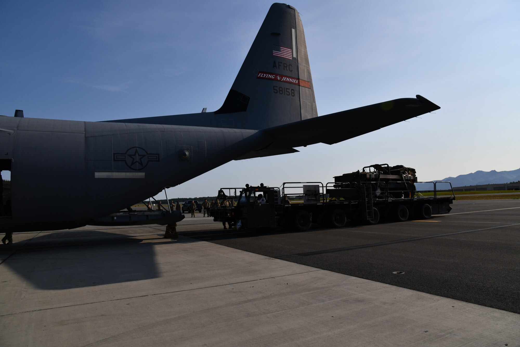 A parachute rigged and palletized Humvee was loaded onto one of the 815th Airlift Squadron's C-130J Super Hercules aircraft for the heavy equipment cargo drop training missions during a training exercise at Joint Base Elmendorf-Richardson, Alaska, July 15, 2021. The 815th AS crews completed three Humvee heavy cargo airdrops totaling over 30,000 pounds of equipment during one formation flight. (U.S. Air Force photo by Master Sgt. Jessica Kendziorek)