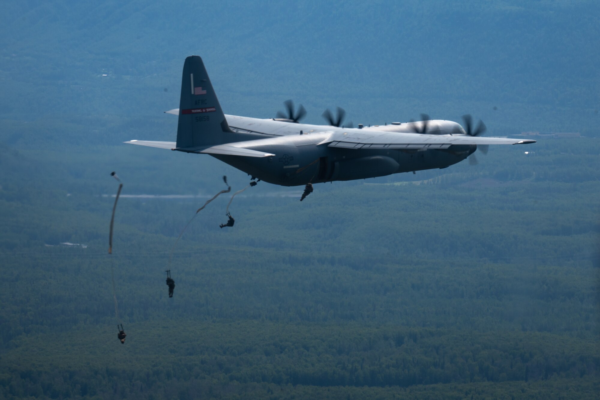 U.S. Army troops from the 4th Brigade Combat Team (Airborne), 25th Infantry Division trained with 815th Airlift Squadron Reserve Citizen Airmen during a training exercise at Joint Base Elmendorf-Richardson, Alaska July 13-16, 2021. The 815th AS provided airlift for more than 1300 paratroopers. (U.S. Air Force photo by Staff Sgt. Shelton Sherrill)