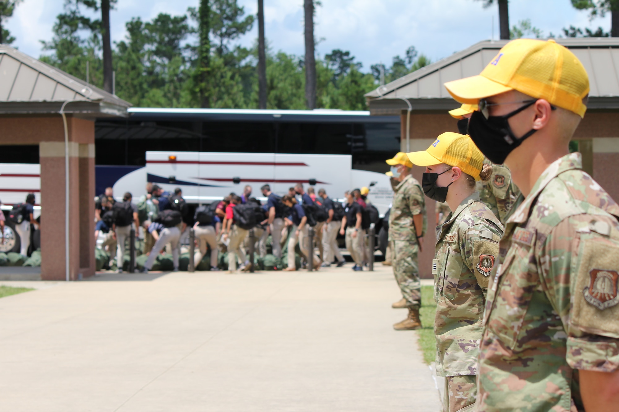 Air Force ROTC Cadet Training Assistants wait as cadets get off the bus
