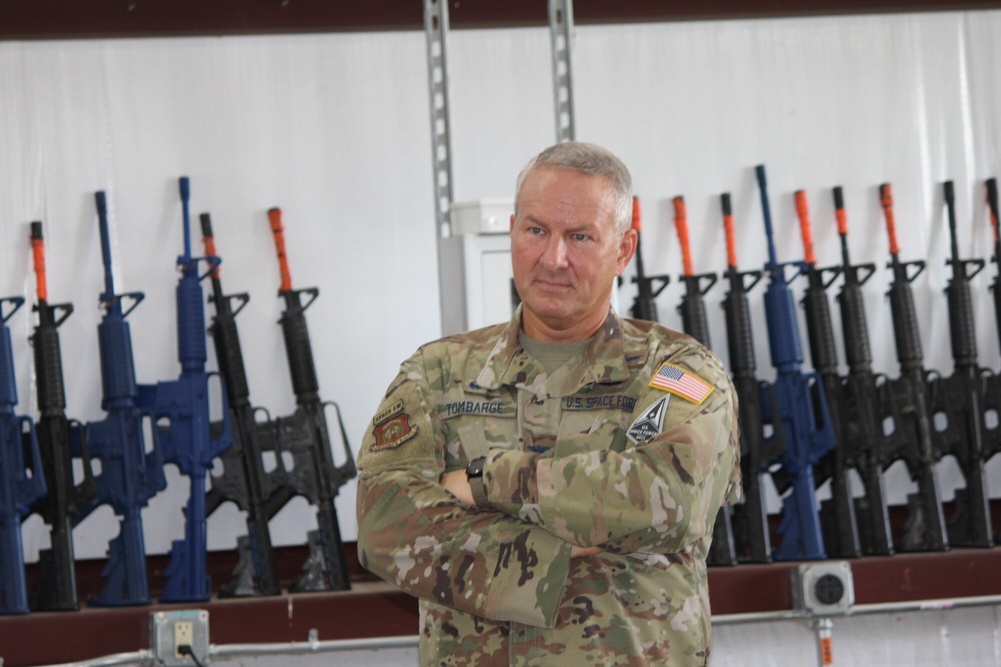 Man stands with arms folded