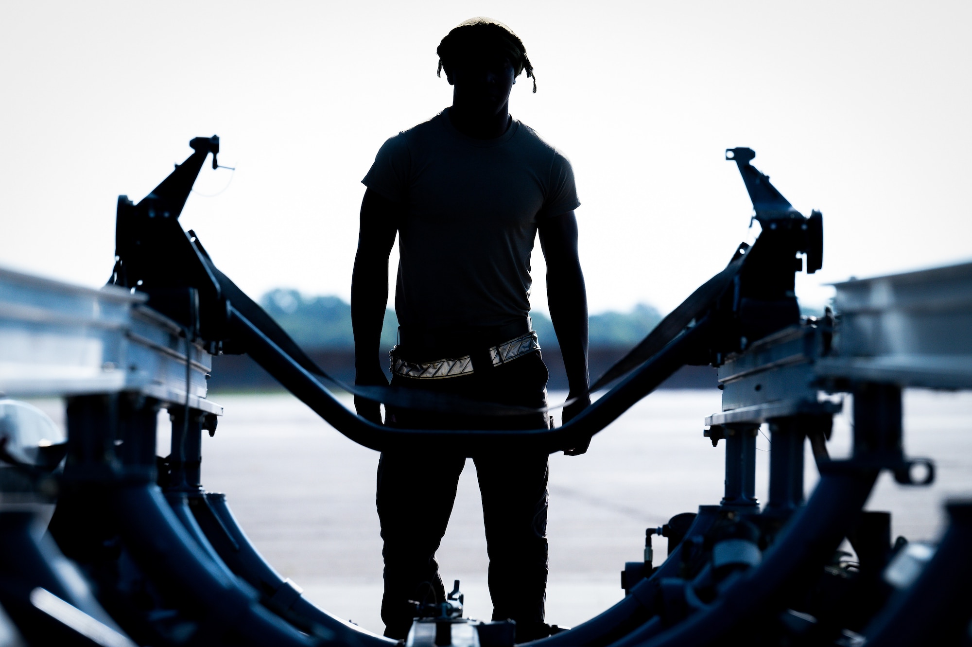 Airman 1st Class Jarrett Scott, 9th Aircraft Maintenance Unit crew chief, prepares to move a 3k trailer into position for removing a F-101 engine from a B-1B Lancer at Barksdale Air Force Base, Louisiana, July 7, 2021.