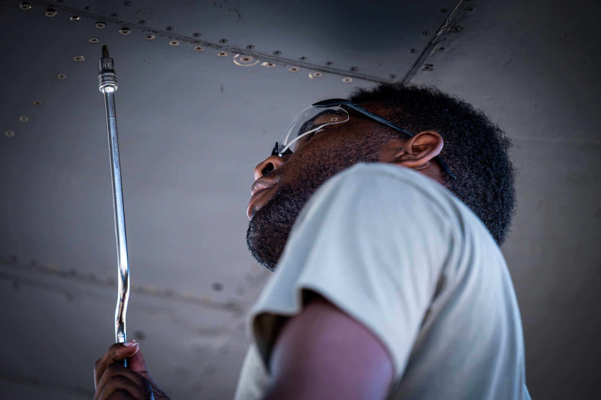 An Airman from Dyess Air Force Base, Texas, removes a panel from a B-1B Lancer’s wing at Barksdale Air Force Base, Louisiana, July 7, 2021.