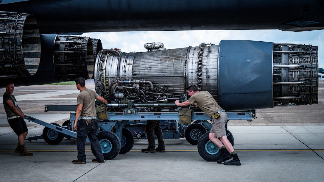 Airmen from Dyess Air Force Base, Texas, remove a F-101 engine from a B-1B Lancer at Barksdale Air Force Base, Louisiana, July 7, 2021.