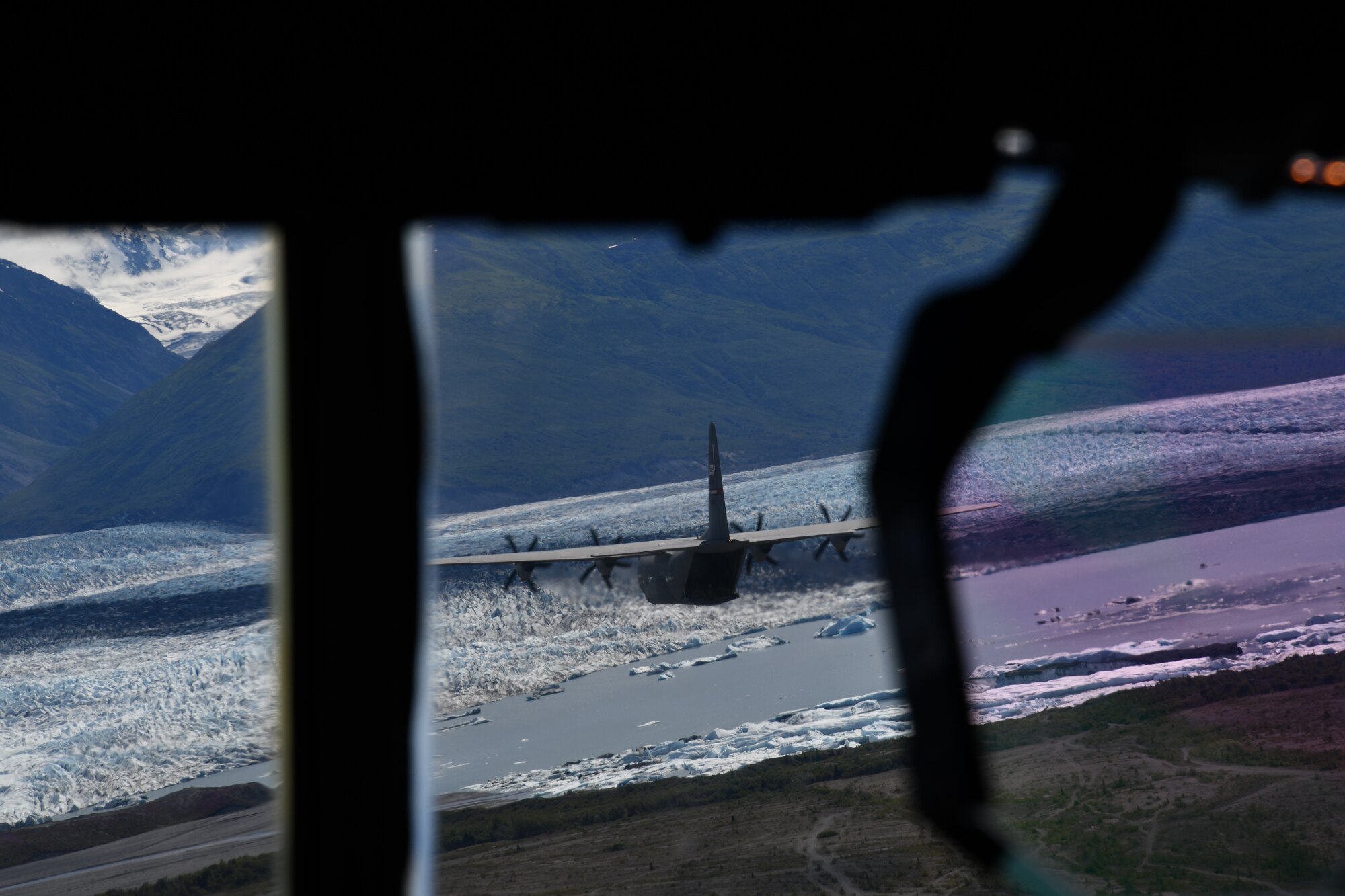 Pilots and loadmasters of the 815th Airlift Squadron conduct low-level tactical flight training patterns during a training exercise at Joint Base Elmendorf-Richardson, Alaska, July 13-16, 2021. The terrain of the mountain, valleys and along with the colder temperatures provided a different challenge for the low-level flights, which were an effective tactic in training for hostile environments. (U.S. Air Force photo by Master Sgt. Jessica Kendziorek)