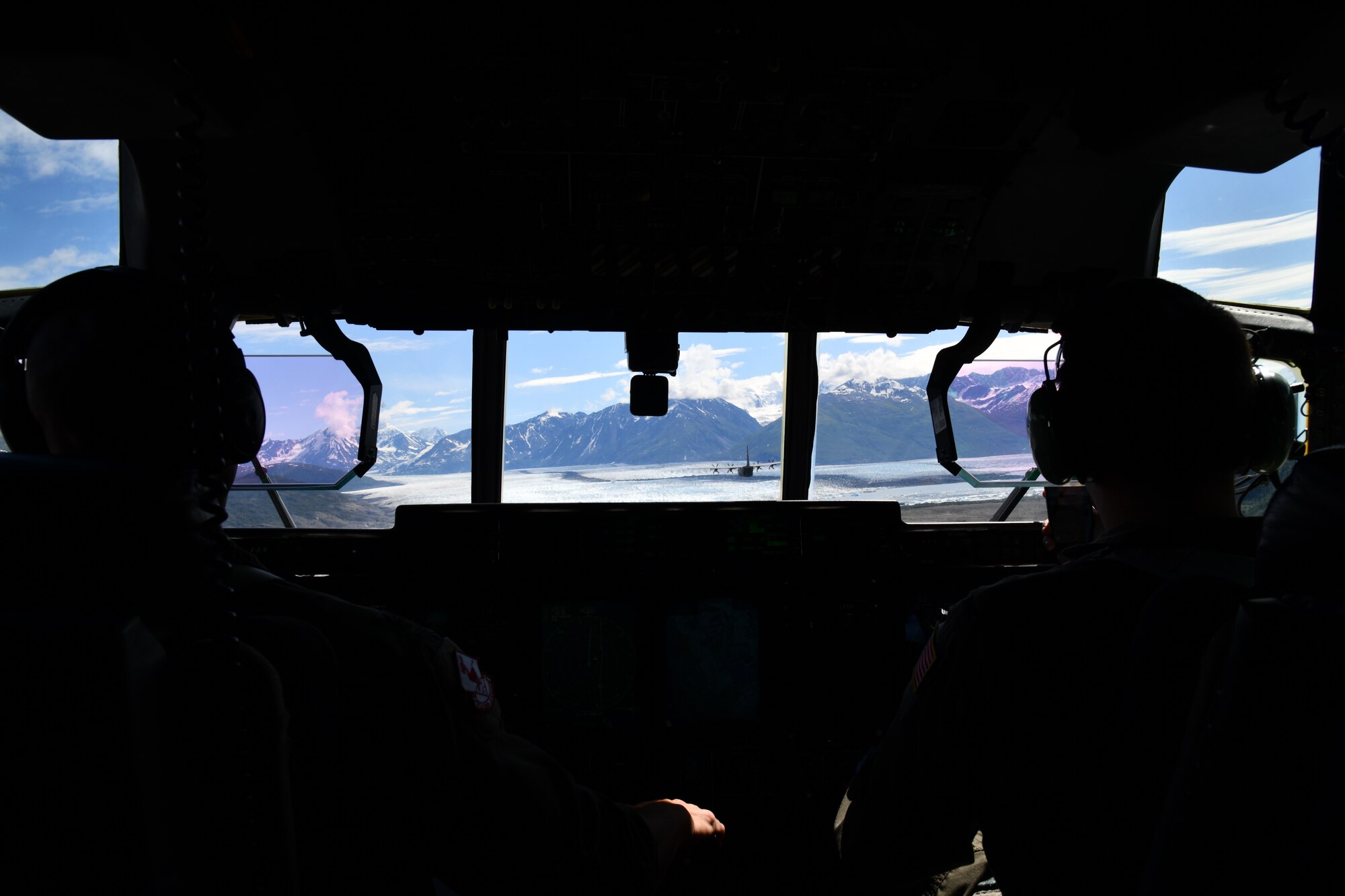 Maj. Scott Schavrien and 1st Lt. James Zock, 815th Airlift Squadron pilots, conduct low-level tactical flight training patterns during a training exercise at Joint Base Elmendorf-Richardson, Alaska, July 13-16, 2021. The terrain of the mountain, valleys and along with the colder temperatures provided a different challenge for the low-level flights, which were an effective tactic in training for hostile environments. (U.S. Air Force photo by Master Sgt. Jessica Kendziorek)