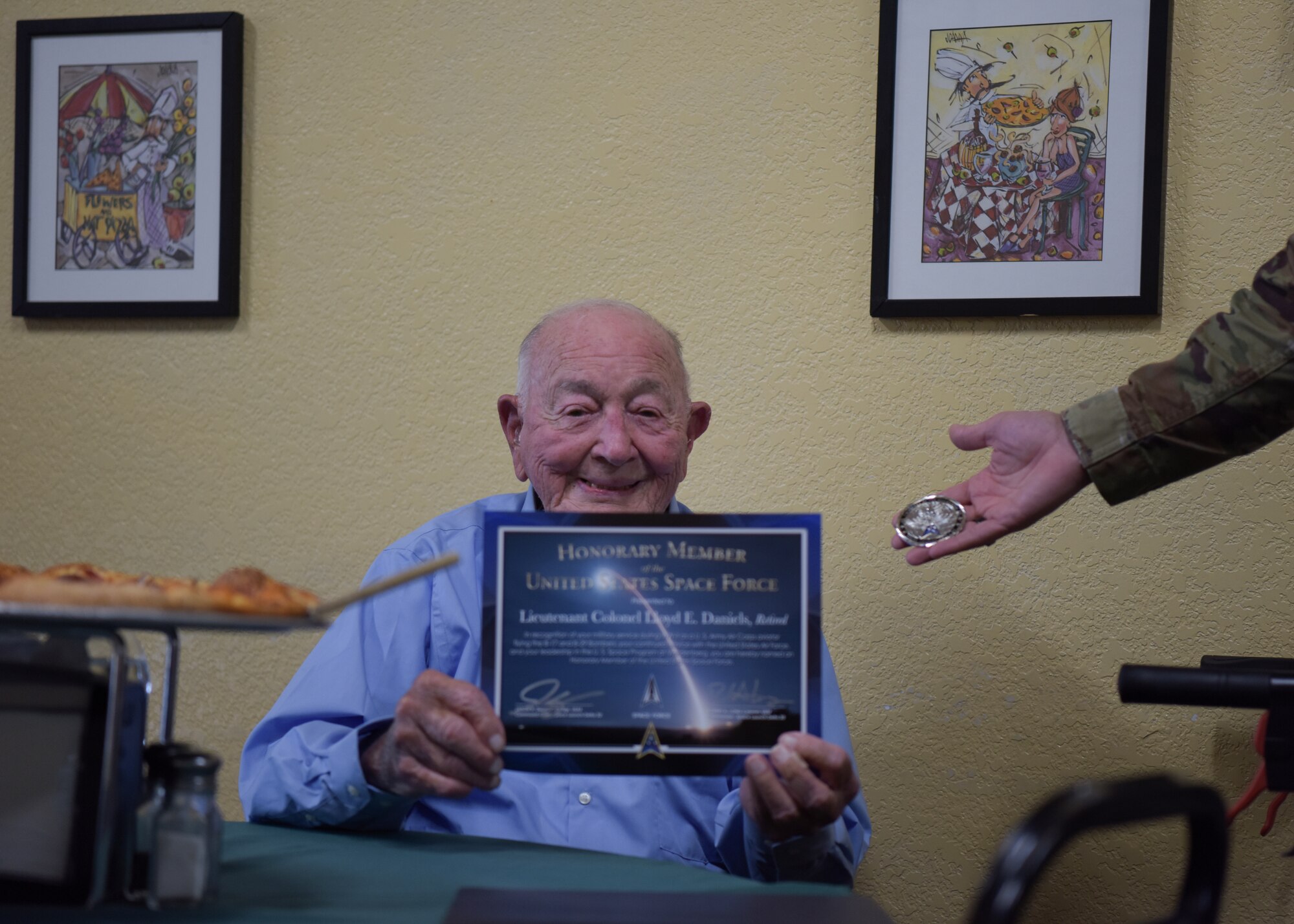 Lt. Col. Lloyd Daniels, retired Air Force veteran, poses with his new certificate and coin presented to him by Col. Robert Long, Space Launch Delta 30 commander, July 16, 2021, in Orcutt, California. Daniels worked directly with General Bernard Schriever, theoretical father of the Space and Missile Program, during his Air Force career. (U.S. Space Force photo by Airman Kadielle Shaw)