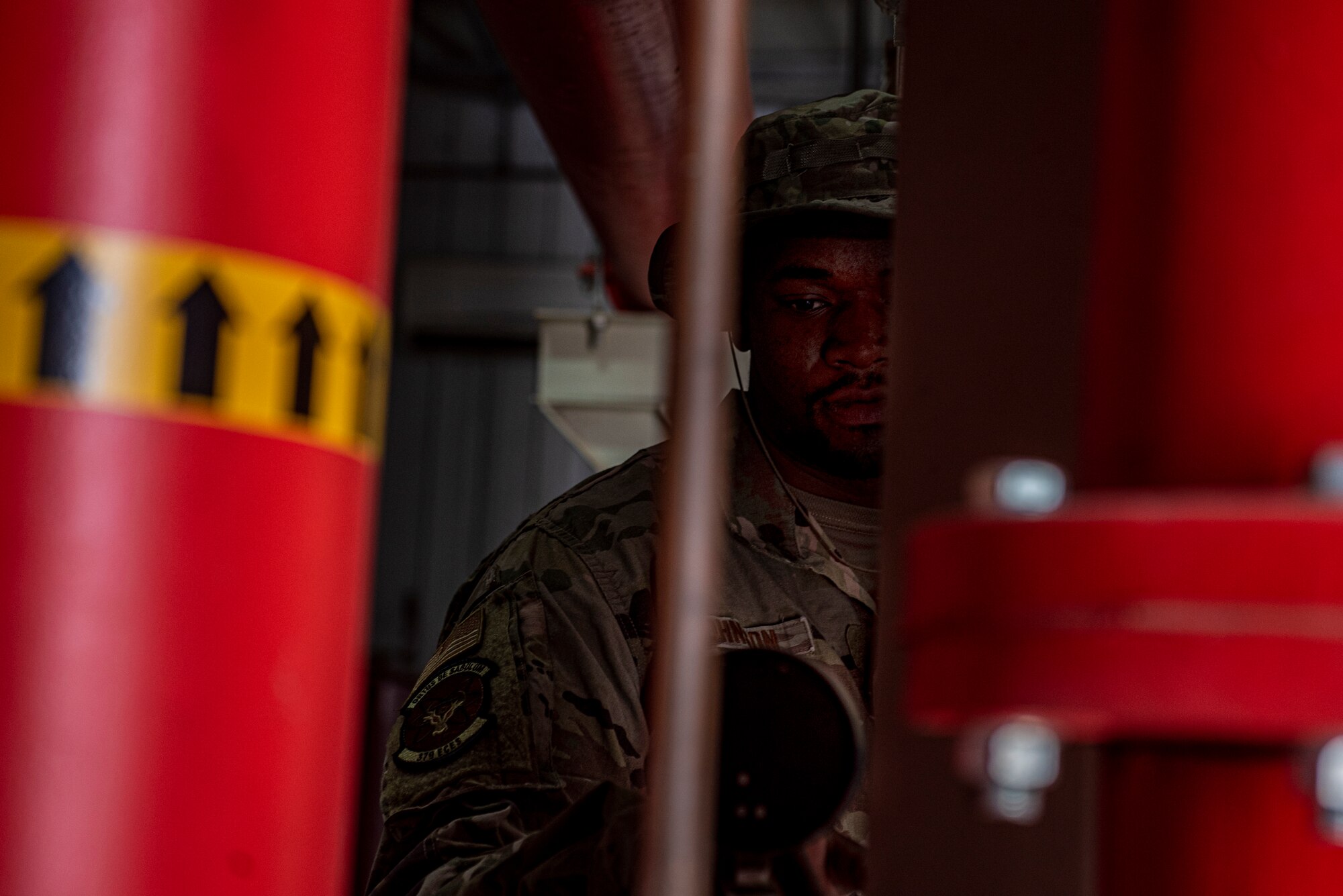Airman 1st Class Brandon Johnson, 379th Expeditionary Civil Engineer Squadron water & fuel systems maintenance journeyman, checks the levels of water storage tanks June 16, 2021 at Al Udeid Air Base, Qatar.