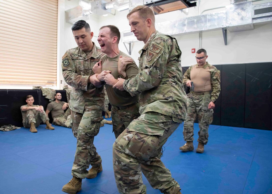 Senior Airman Cody Tedder, 374th Civil Engineer Squadron electrical power production technician, experiences a taser electroshock during a 374th Mission Support Group training day at Yokota Air Base, Japan, July 21, 2021.