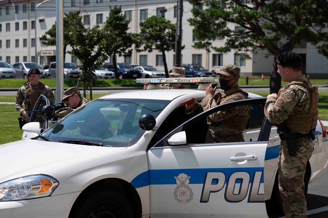 Airmen from the 374th Mission Support Group participate in a high-risk traffic stop scenario during a 374th MSG training day at Yokota Air Base, Japan, July 21, 2021.
