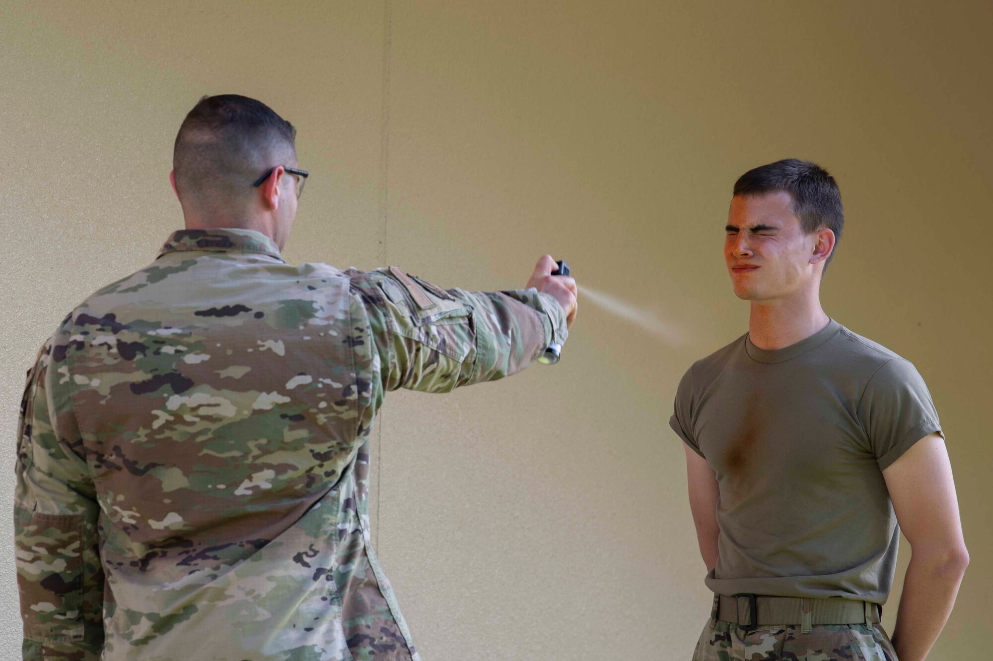 Airman John Larson, 374th Logistics Readiness Squadron vehicle mechanic, receives oleoresin capsicum spray during a 374th Mission Support Group training day at Yokota Air Base, Japan, July 21, 2021.