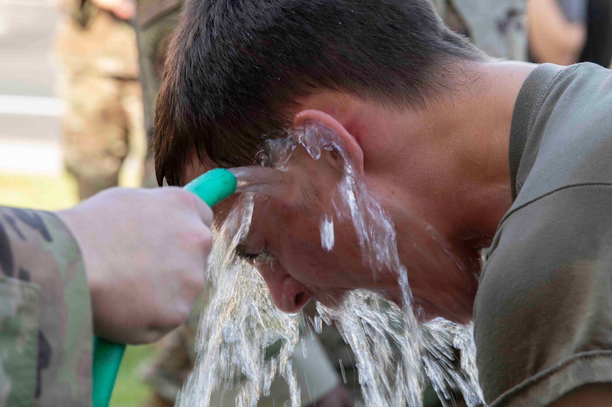 Airman John Larson, 374th Logistics Readiness Squadron vehicle mechanic, washes off oleoresin capsicum spray during a 374th Mission Support Group training day at Yokota Air Base, Japan, July 21, 2021.