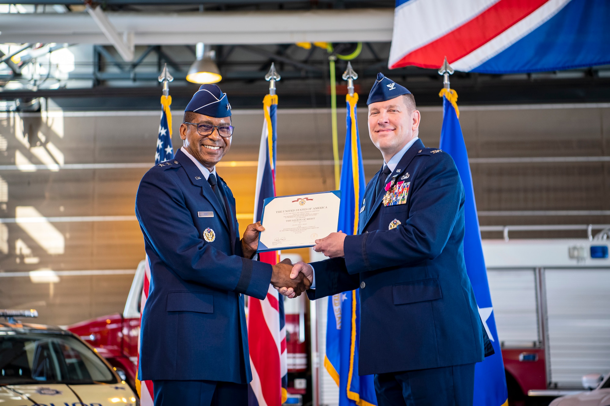 U.S. Air Force Maj. Gen. Randal Reed, left, Third Air Force commander, presents a Legion of Merit decoration during a change of command ceremony at RAF Alconbury, England, July 20, 2021.  The Legion of Merit is a military award of the United States Armed Forces that is given for exceptionally meritorious conduct in the performance of outstanding services and achievements.  (U.S. Air Force photo by Senior Airman Eugene Oliver)