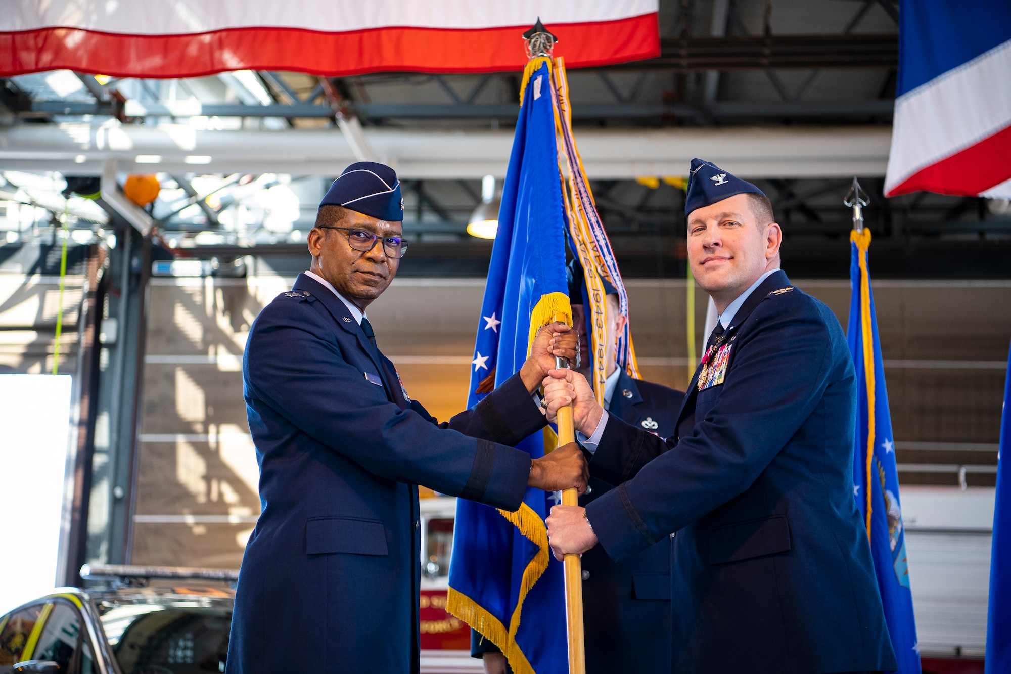 U.S. Air Force Maj. Gen. Randall Reed, Third Air Force commander, left, receives the 501st Combat Support Wing guidon from Col. Kurt Wendt, 501 CSW outgoing commander, during a change of command ceremony at RAF Alconbury, England, July 20, 2021.  The ceremony is a military tradition that represents a formal transfer of a unit’s authority and responsibility from one commander to another. (U.S. Air Force photo by Senior Airman Eugene Oliver)