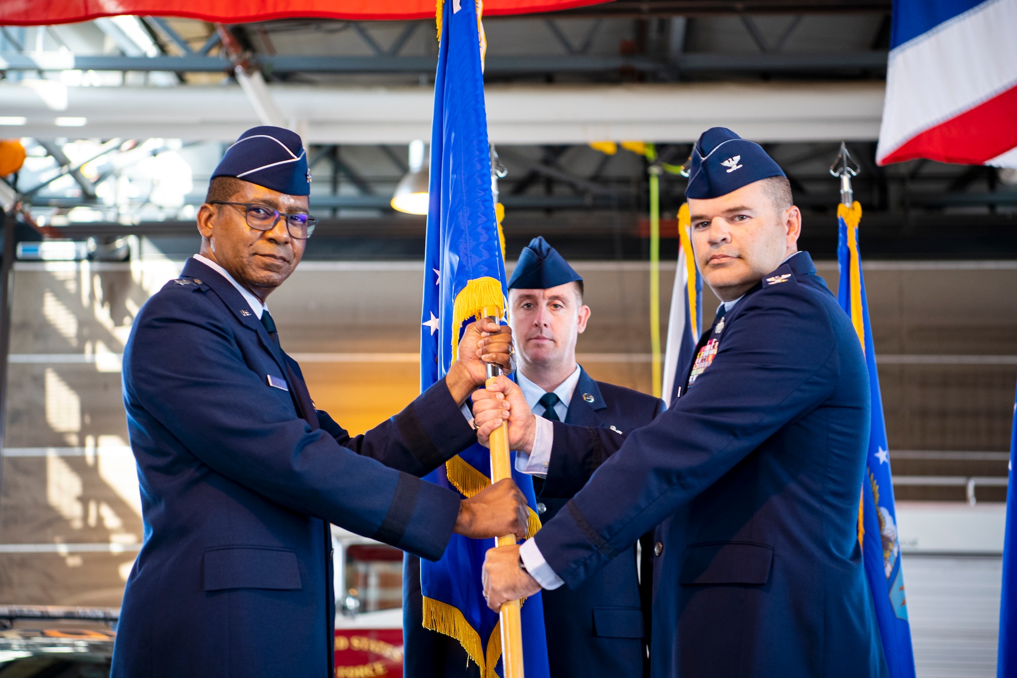 U.S. Air Force Maj. Gen. Randall Reed, left, Third Air Force commander, presents the 501st Combat Support Wing guidon to Col. Brian Filler, 501 CSW incoming commander, during a change of command ceremony at RAF Alconbury, England, July 20, 2021. Prior to assuming command of the 501st CSW, Filler served as the Vice commander of the 39th Air Base Wing, Incirlik Air Base, Turkey.  (U.S. Air Force photo by Senior Airman Eugene Oliver)