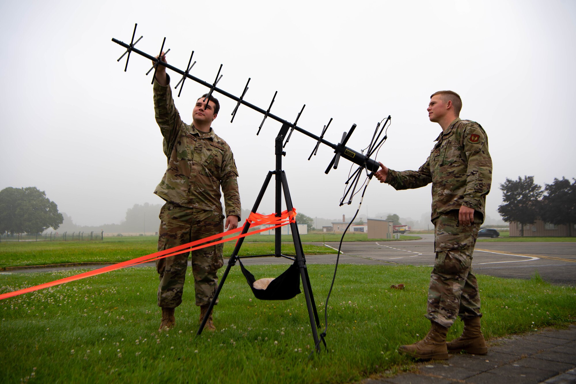 U.S. Air Force airmen set up an antenna in fog