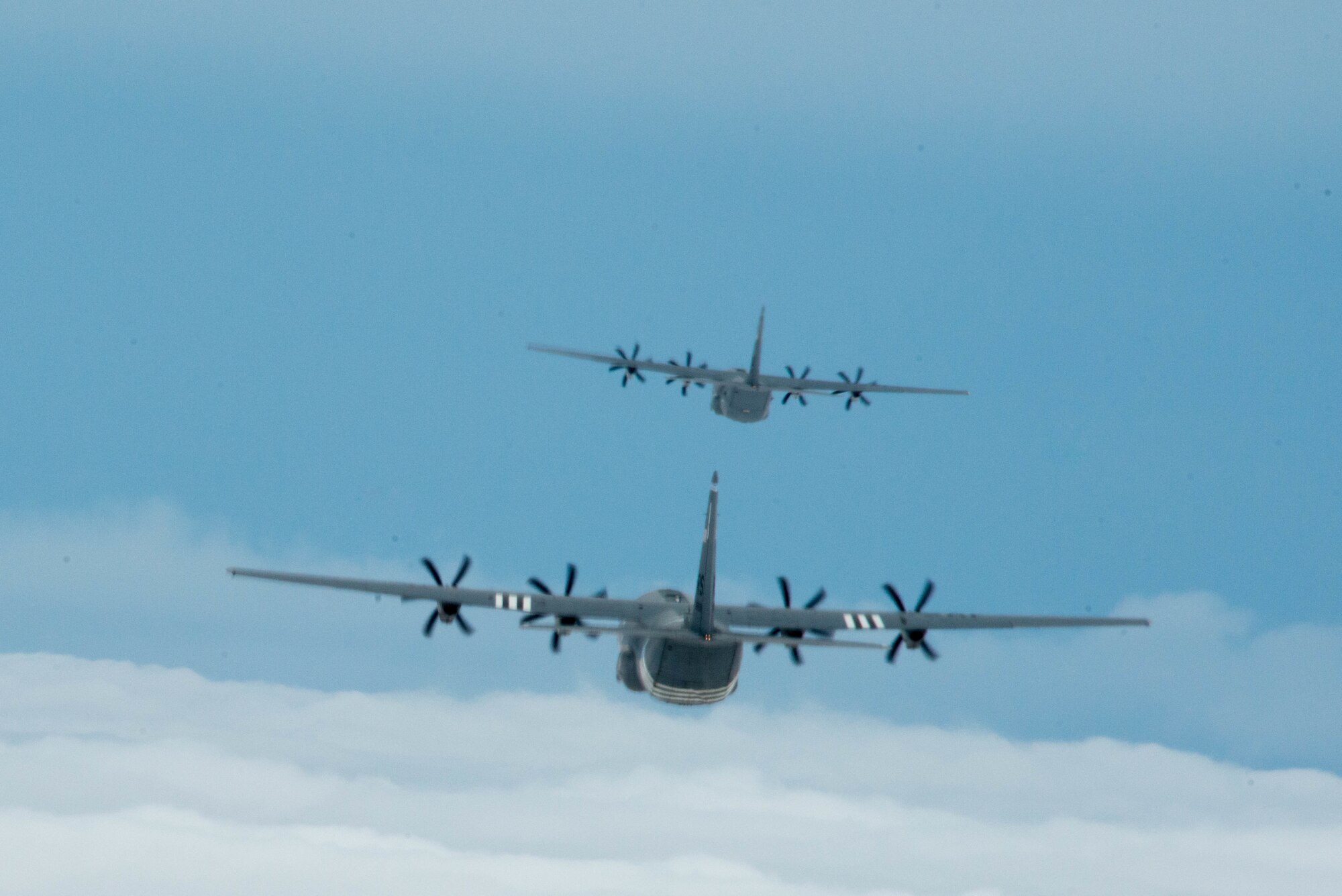 Two U.S. Air Force C-130J Super Hercules aircraft fly in formation