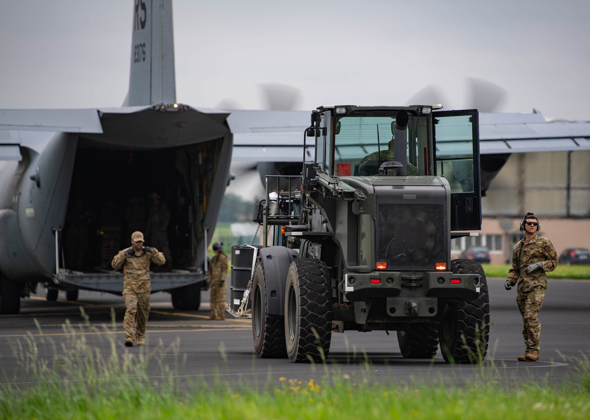 U.S. Air Force Airmen use a forklift to load cargo on aircraft