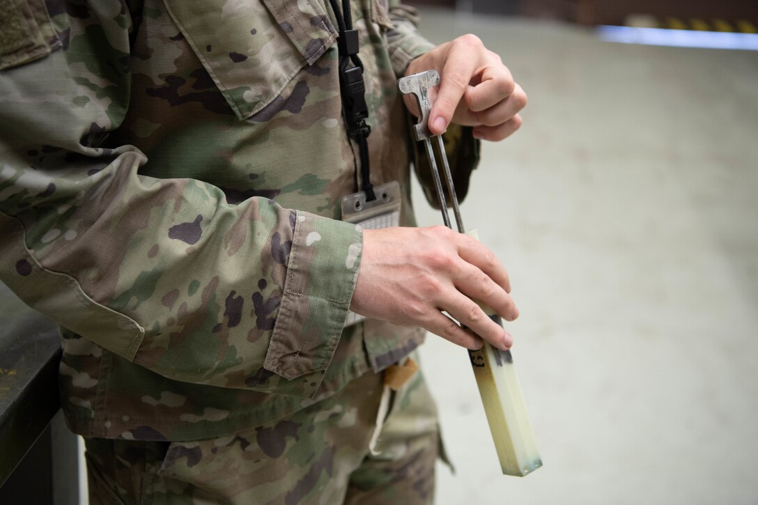 Airman demonstrates how to use tool to clear chaff