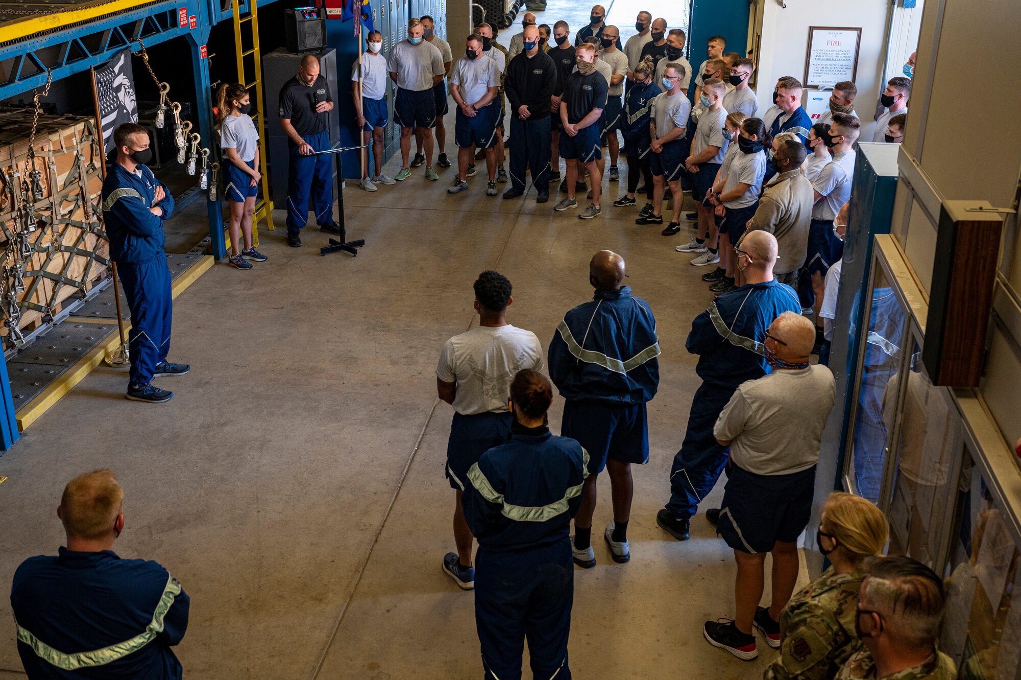 Airmen assigned to the 32nd Aerial Port Squadron gather around a display that honors fallen aerial port Airmen before running the Port Dawg Memorial Run at the Pittsburgh International Airport Air Reserve Station, Pennsylvania, May 1, 2021. The PDMR started in 2013 at Kadena Air Base, Japan, when aerial port Airmen wanted a way to pay their respects to one of their fallen fellows, Tech. Sgt. Curtis E. Eccleston.