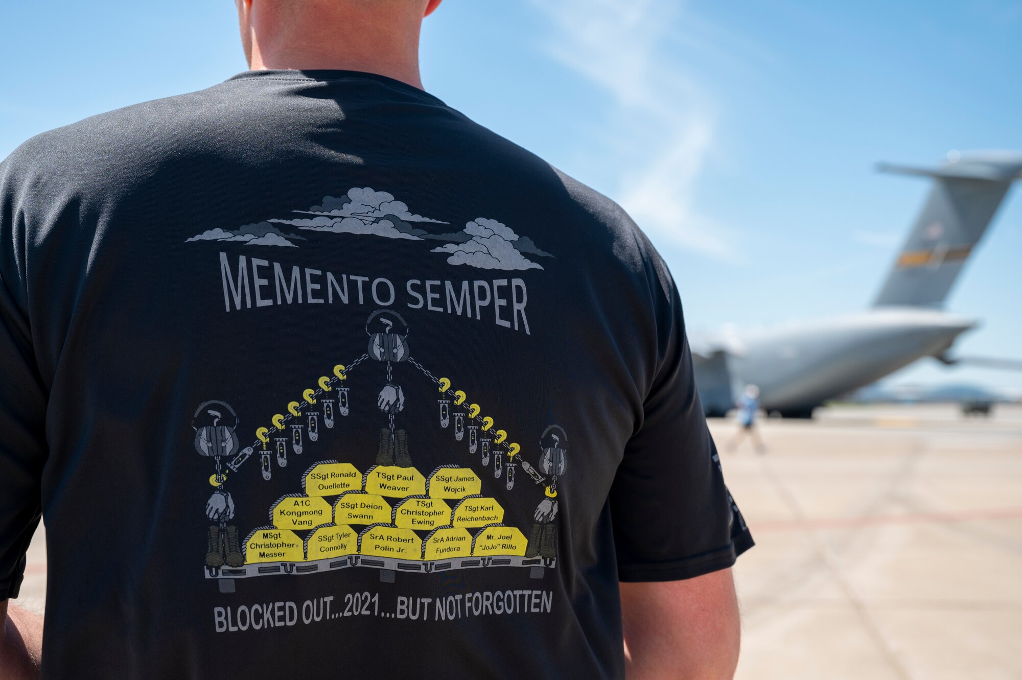 Chief Master Sgt. Michael Heim, 32nd Aerial Port Squadron superintendent, waits for fellow Airmen to finish the annual Port Dawg Memorial Run at the Pittsburgh International Airport Air Reserve Station, Pennsylvania, May 1, 2021. The names on the back of the shirt are aerial port Airmen that have passed since last year.