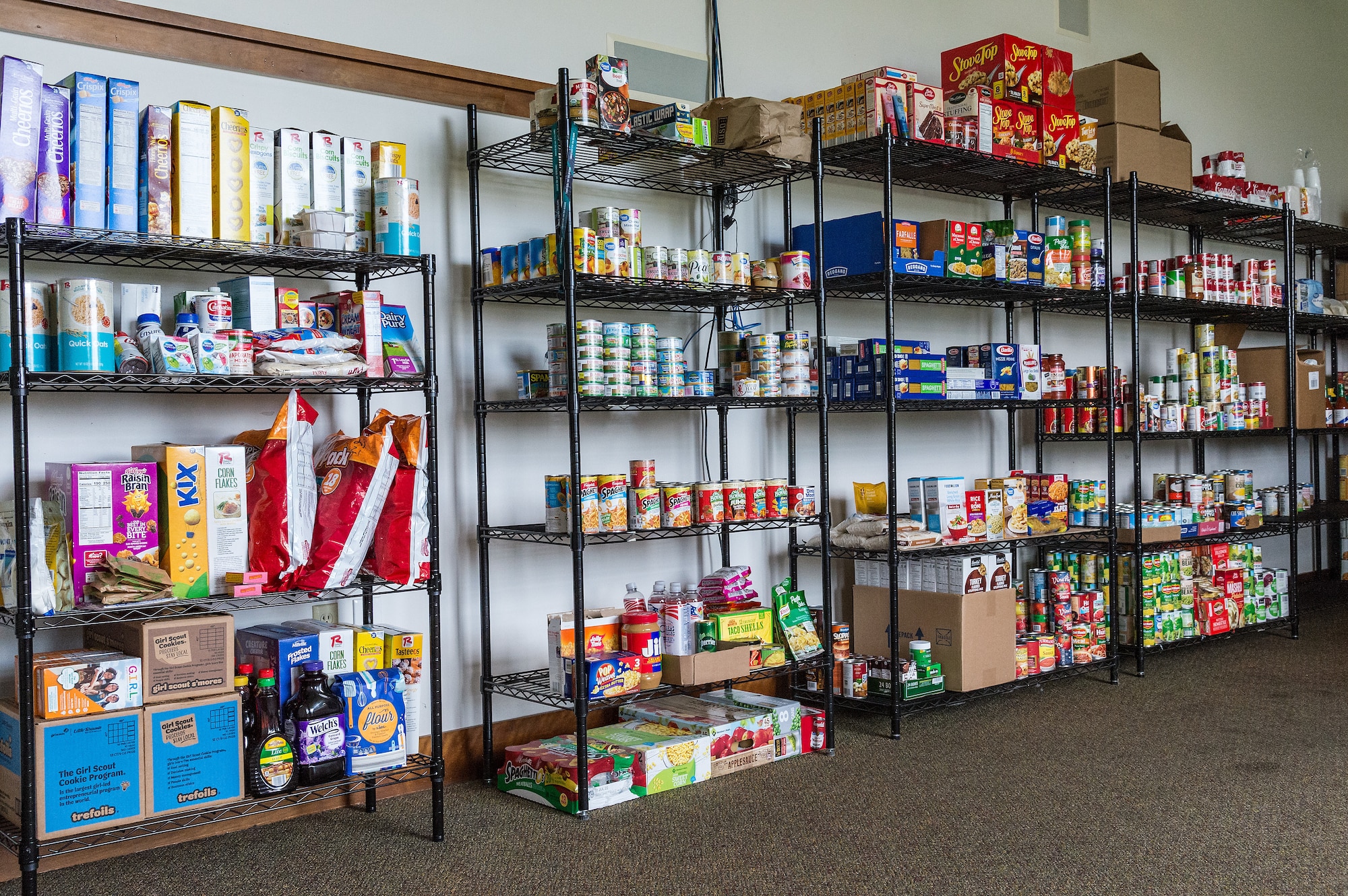 Food and non-perishable items sit on shelves in the Airman's Attic food pantry at Dover Air Force Base, Delaware, July 16, 2021. The pantry provides dorm Airmen a place to obtain donated items while the Patterson Dining Facility undergoes renovations. (U.S. Air Force photo by Roland Balik)