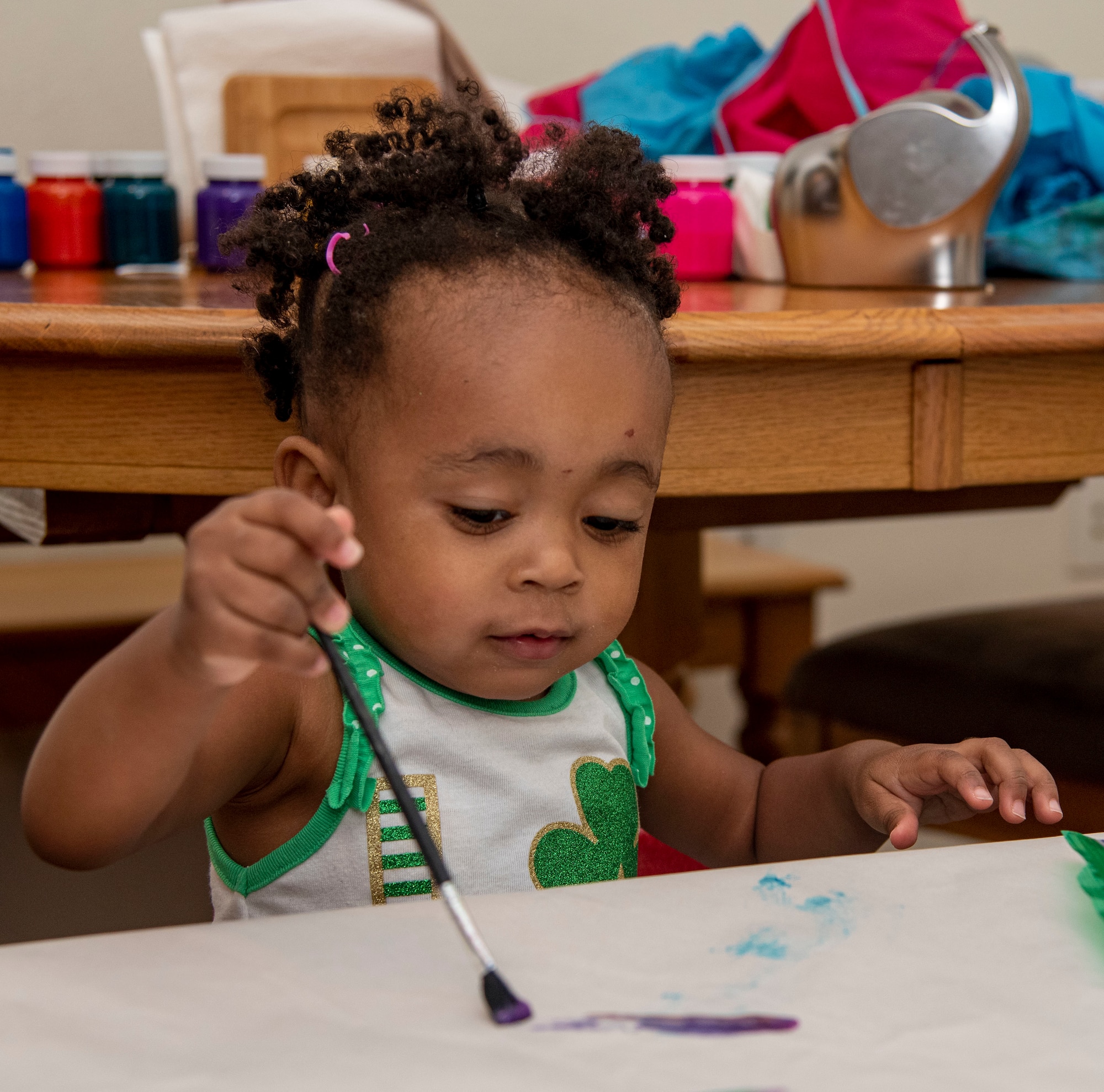 Amani Bailey, daughter of Tech. Sgt. Justin Bailey, 436th Aerial Port Squadron noncommissioned officer in charge of passenger services, paints as part of the Family Child Care program on Dover Air Force Base, Delaware, July 20, 2021. The FCC program offers an alternate option to the Child Development Center or Youth Center on base, providing in-home care for infants through school-aged children. (U.S. Air Force photo by Tech. Sgt. Nicole Leidholm)
