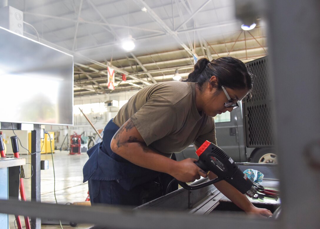 U.S. Air Force Staff Sgt. Viridiana Hernandez, 912th Air Refueling Squadron aerospace ground equipment technician, fixes a battery cable on a generator at March Air Reserve Base, California, July 15, 2021.