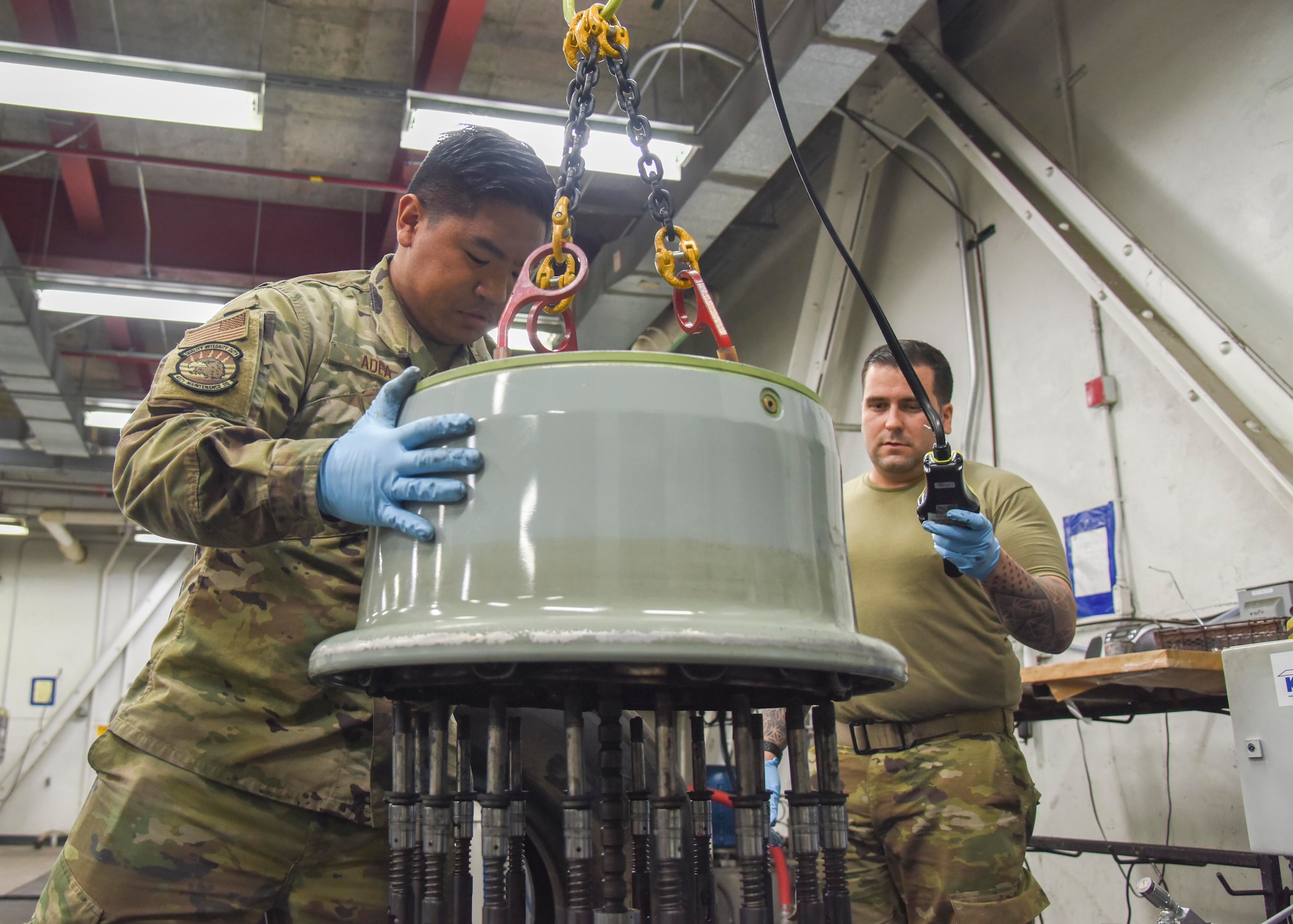 (left) U.S. Air Force Staff Sgt. Lester Adea, 452nd Maintenance Squadron repair and reclamation maintainer, and (right) U.S. Air Force Staff Sgt. Kyle Hauck, 912th Air Refueling Squadron repair and reclamation maintainer, operate a machine to repair a tire at March Air Reserve Base, California, July 15, 2021.