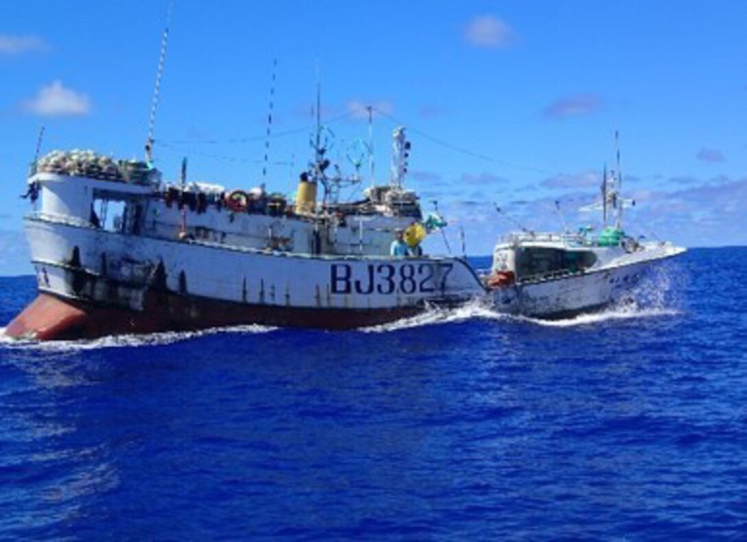 A fishing vessel bobs in the sea.