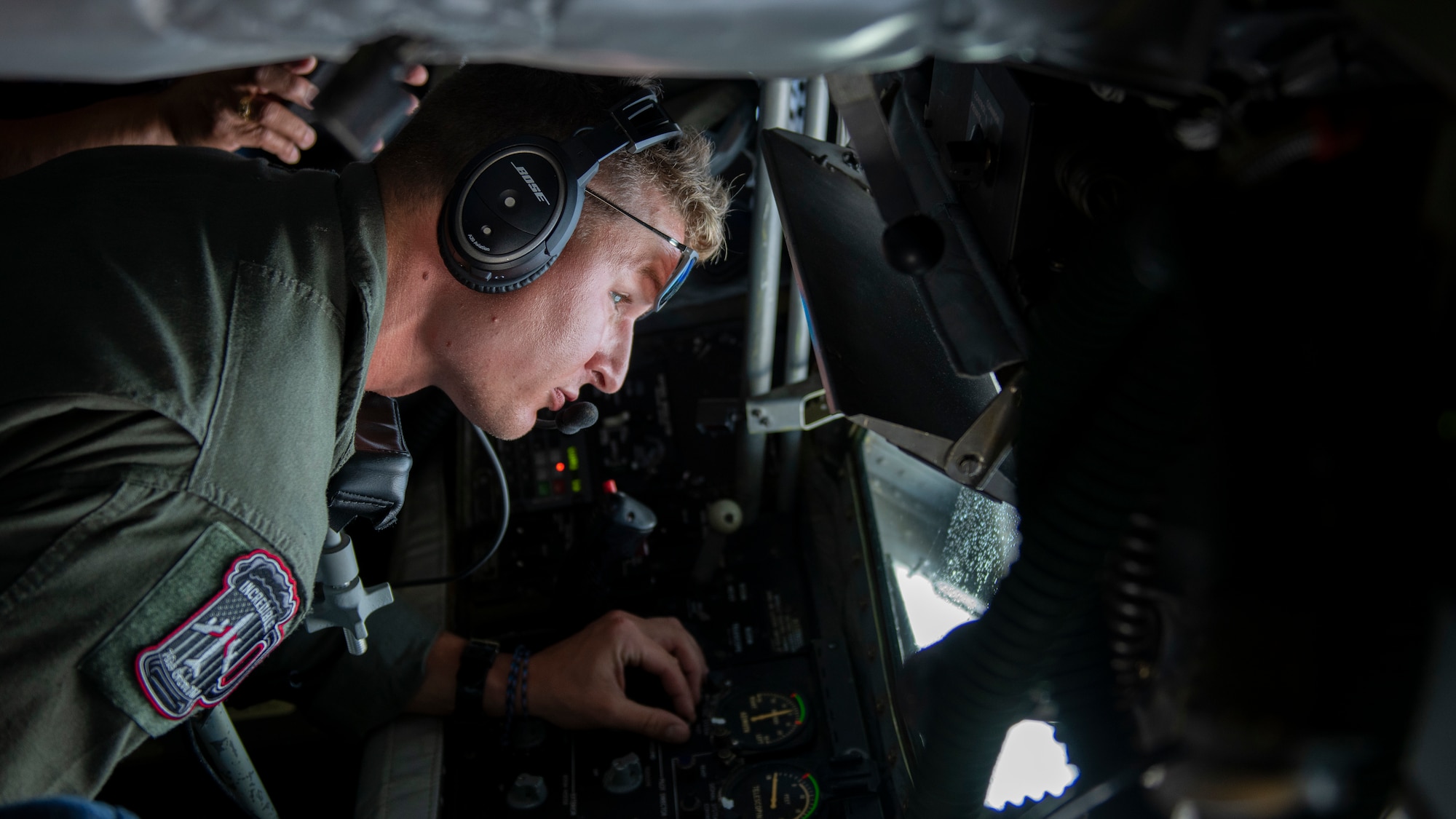 Man looks out window of aircraft