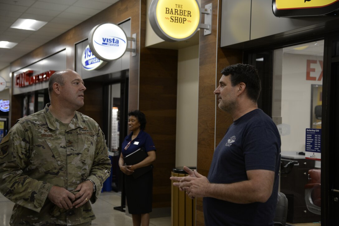 Col. Patrick Miller, 88th Air Base Wing and installation commander, talks with Bunker 27 founder and owner Darren Moore during the store’s opening July 15 at Wright-Patterson Air Force Base. A ribbon-cutting ceremony was held for the veteran-owned clothing company at the Base Exchange.