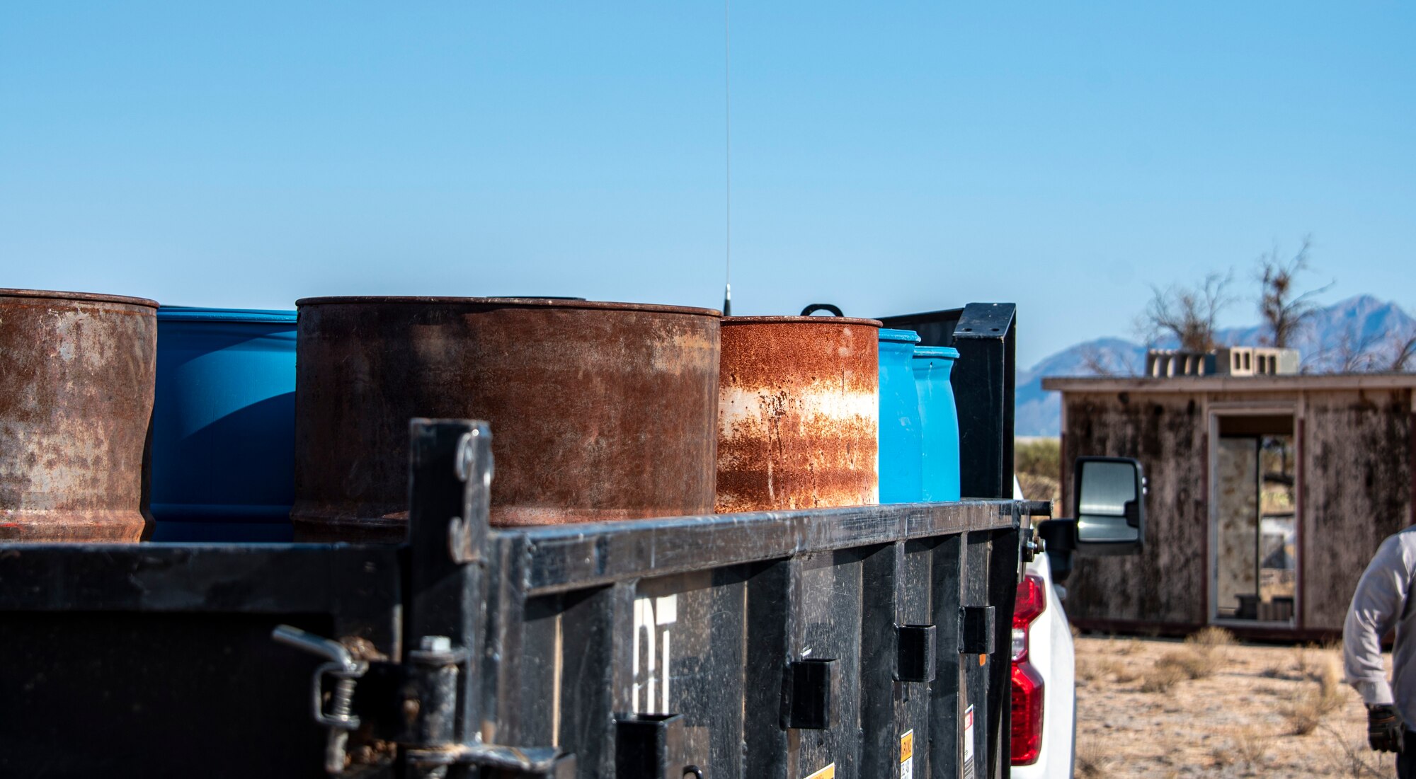 A photo of 55-gallon drums on a truck.