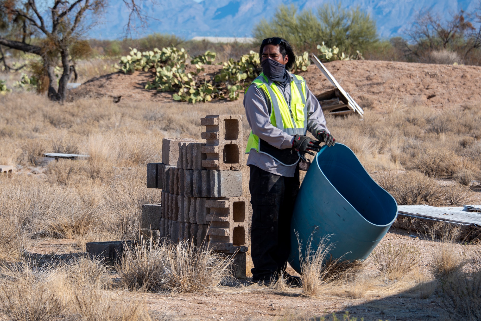 A photo of a person with a 55-gallon drum.