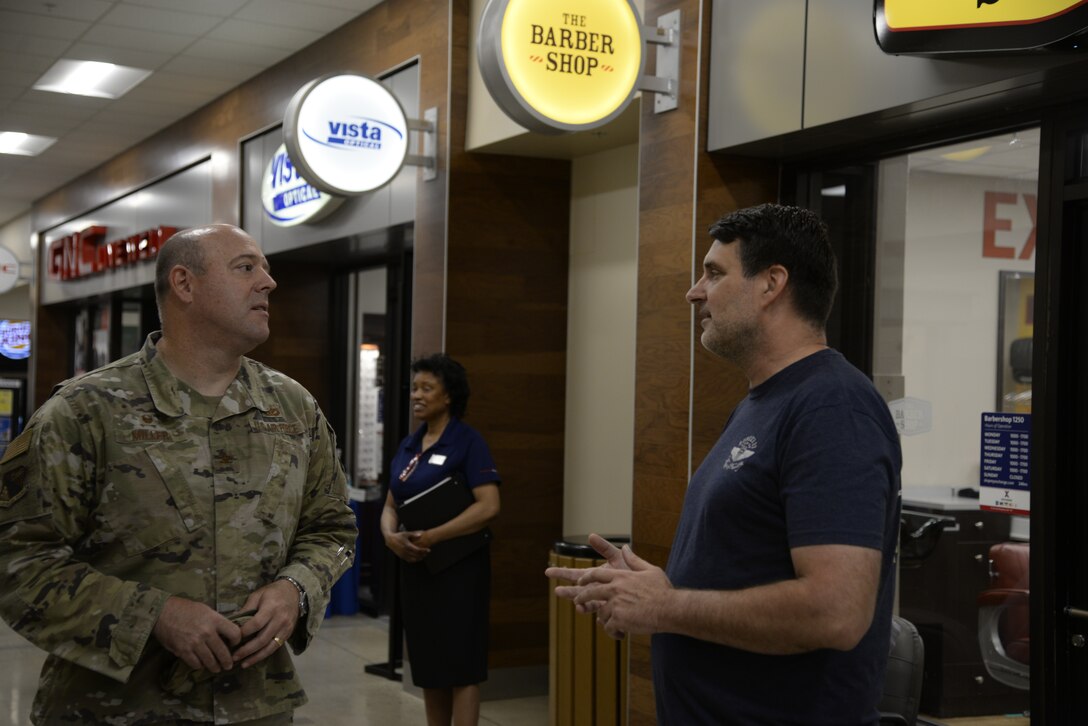 Col. Patrick Miller, 88th Air Base Wing and installation commander, talks with Bunker 27 founder and owner Darren Moore during the store’s opening July 15 at Wright-Patterson Air Force Base. A ribbon-cutting ceremony was held for the veteran-owned clothing company at the Base Exchange. (U.S. Air Force photo by Airman 1st Class Jack Gardner)
