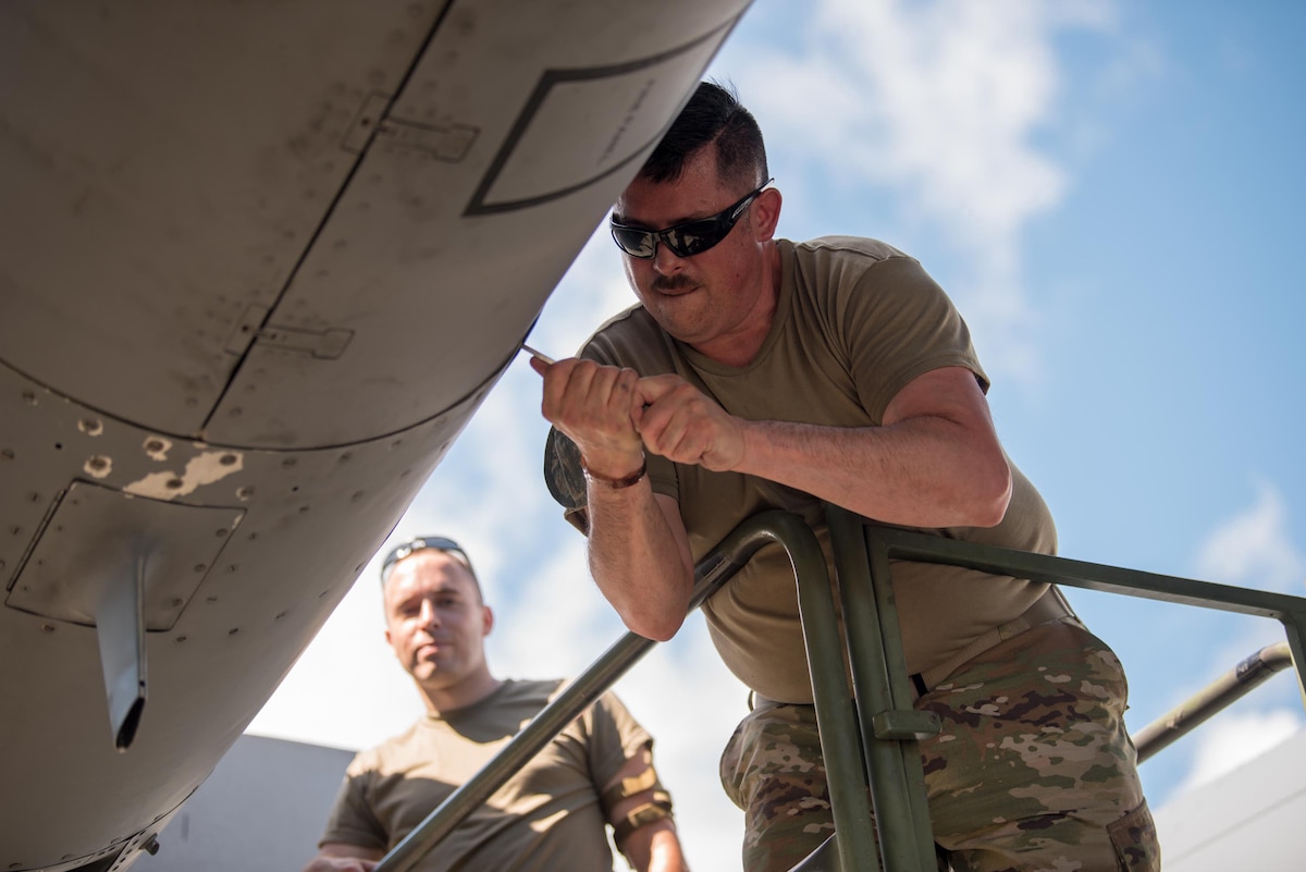 Master Sgt. Chuck Rodgers (right), a propulsion elements supervisor from the Kentucky Air National Guard’s 123rd Maintenance Squadron, and Staff Sgt. Mike Hasson, an aerospace maintenance craftsman from the same unit, install engine panels on a C-130 Hercules at Muñiz Air National Guard Base in Carolina, Puerto Rico, on June 13, 2021, as part of Maintenance University. More than 130 Airmen from the Kentucky Air Guard’s 123rd Airlift Wing trained on career-specific proficiencies during the intensive week-long course. (U.S. Air National Guard photo by Phil Speck)