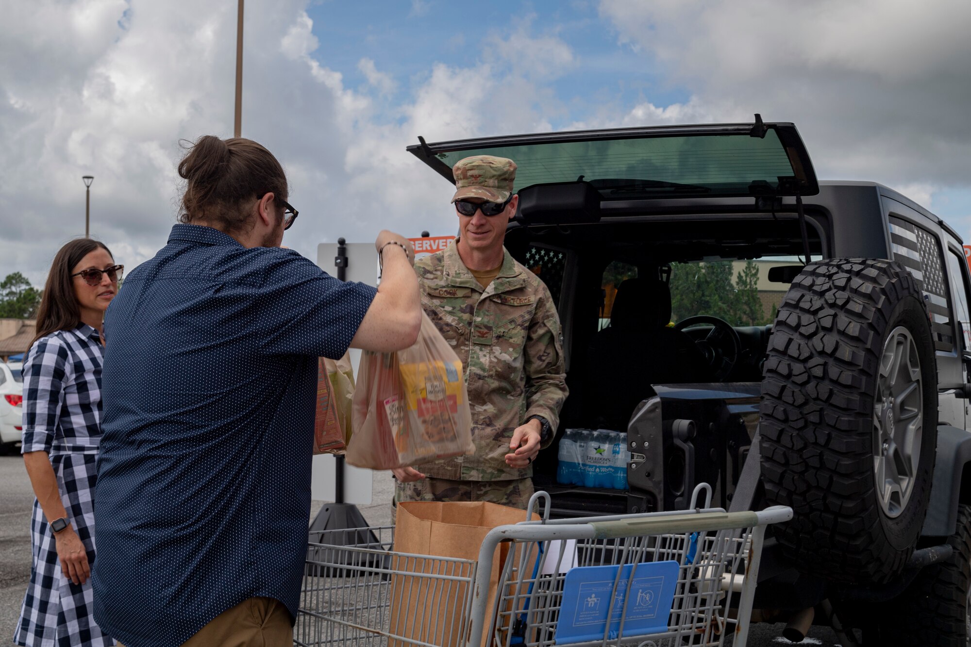 Photo of an Airman receiving groceries
