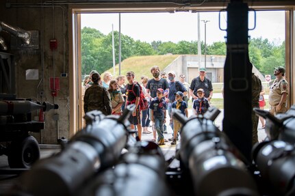 Children from a local scout group along with civilians look into a munitions bunker during a group tour of the Vermont Air National Guard base.