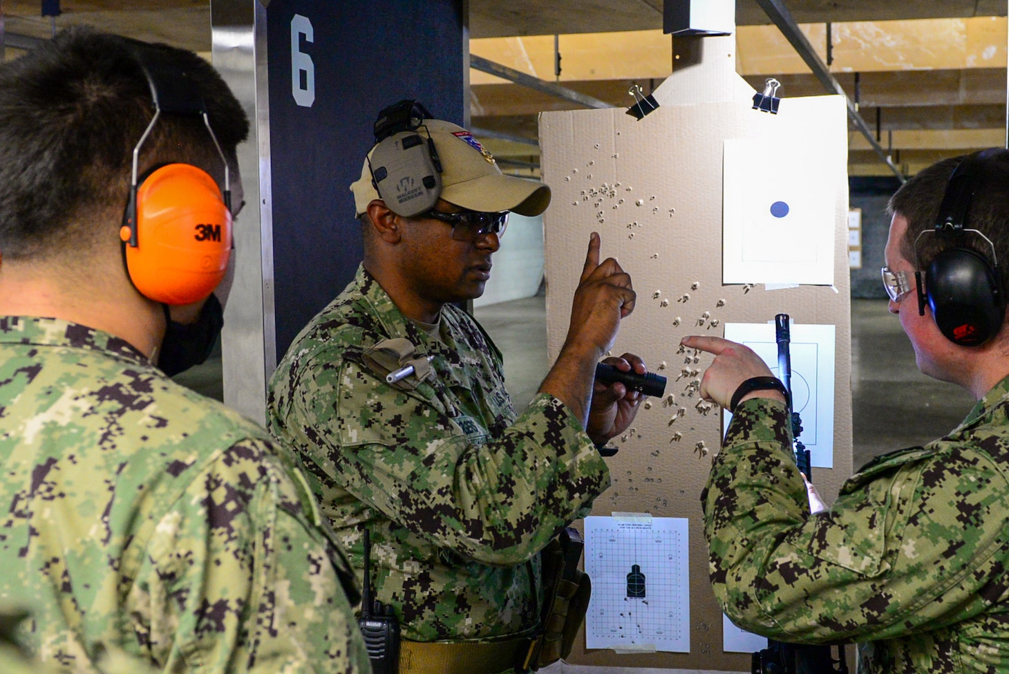 Chief Master-at-Arms Joe Rogers (center), the senior enlisted leader at Navy Reserve Naval Security Forces Fort Worth instructs Sailors during a weapons qualification exercise held at the small arms range aboard Naval Air Station Fort Worth Joint Reserve Base. The exercise is part of a Navy-wide sustainment training requirement for all Sailors designated as armed watch standers. (U.S. Navy photo by Mass Communication Specialist 1st Class Lawrence Davis)