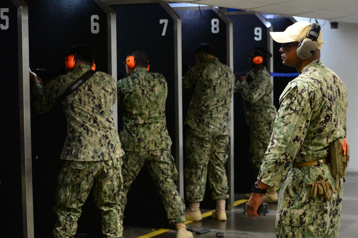 Chief Master-at-Arms Joe Rogers (right), the senior enlisted leader for Navy Reserve Naval Security Forces Fort Worth, observes his Sailors in the process of a weapons qualification exercise held at the small arms range aboard Naval Air Station Fort Worth Joint Reserve Base. The exercise is part of a Navy-wide sustainment training requirement for all Sailors designated as armed watch standers. (U.S. Navy photo by Mass Communication Specialist 1st Class Lawrence Davis)